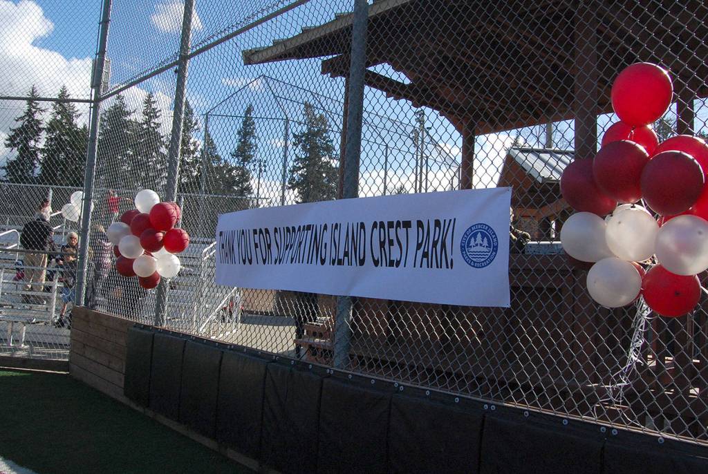 A banner hangs on the backstop at the grand re-opening for Island Crest Park on March 14. Katie Metzger/staff photo