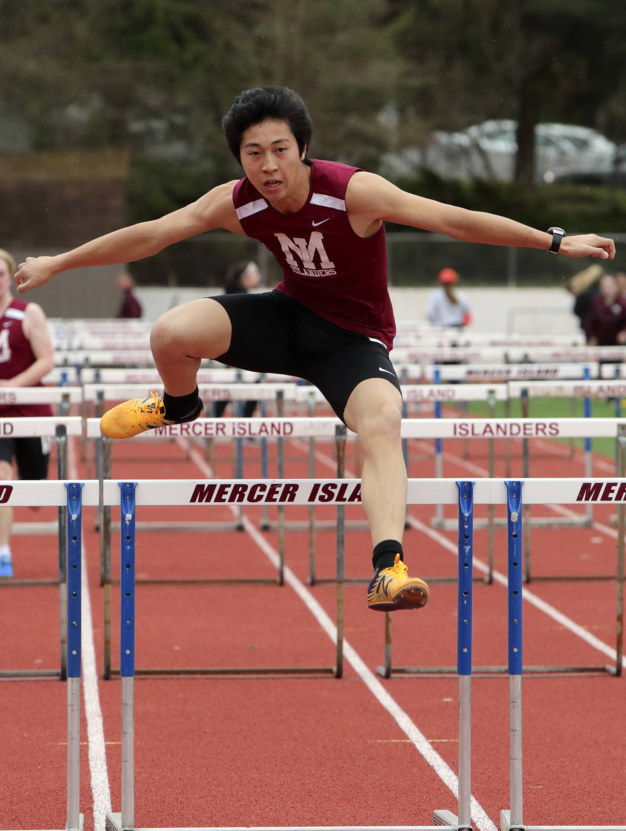 Photo courtesy of Jay Na                                The Mercer Island Islanders girls track team improved their overall record to 4-0 courtesy of a 89-56 win against Interlake and a 91-58 victory against the Redmond Mustangs in a KingCo 3A/2A double dual on March 29 on Mercer Island.                                The Mercer Island boys squad lost to Interlake 76-69 and were defeated by Redmond 98-57. Islanders girls athletes capturing first place in their respective events consisted of Maya Virdell (100 meters, 1600 meter-relay), Gretchen Blohm (200 meters, 800 meter-relay), Kayla Lee (400 meters, 800 meter-relay, 1600 meter-relay), Katie McCormick (100 meter hurdles), Ella Hensey (800 meter-relay, 1600 meter-relay), Eliza Crenshaw (800 meter-relay), Margaret Baker (1600 meter-relay), Faith Osei-Tutu (shot-put, javelin) and Susanna Lepow (pole vault). Islanders boys athletes earning first place in their events were Colin Farrell (100 meters, 200 meters), Jack Clayville (110 hurdles), Mitchell Kirby (300 hurdles), Eli Yen (discus) and Jeffery Tian (pole vault). Yian (pictured) competes in the 110 hurdles in a double dual against the Interlake Saints and Redmond Mustangs on March 29.