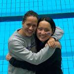 Islander teammates Alex Seidel and Sabrina Kwan pose in front of the pool where they competed in the NCAA D3 National Swimming and Dive Championships.