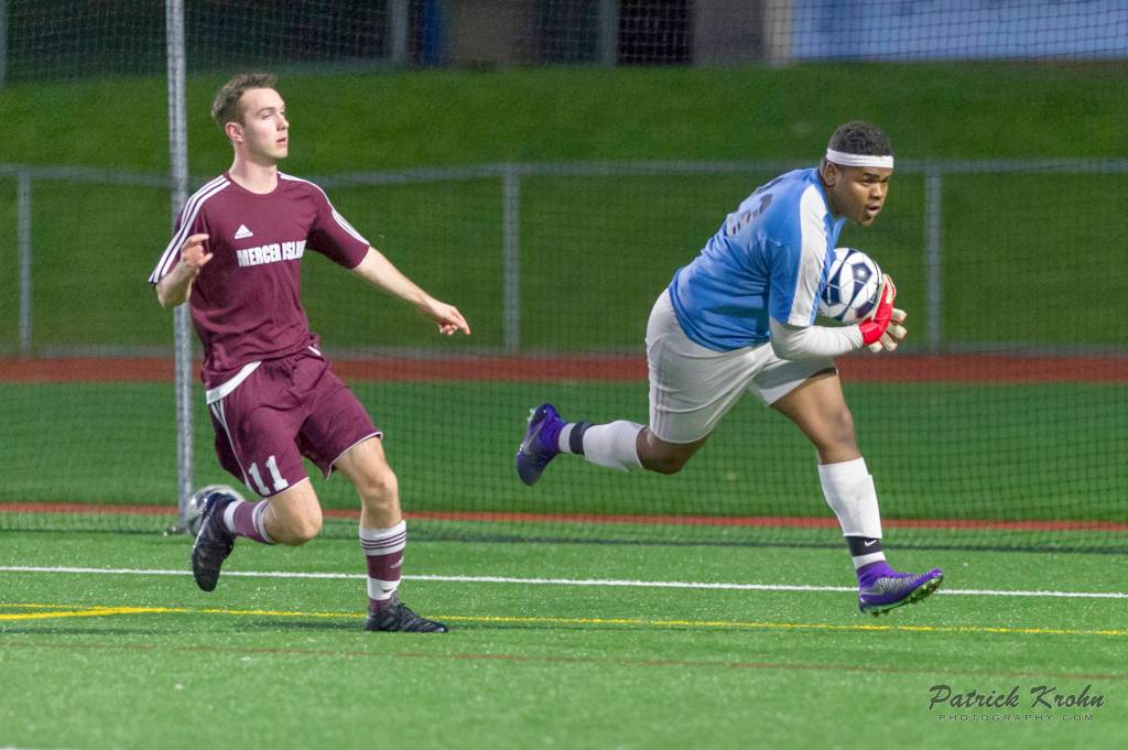 Photo courtesy of Patrick Krohn/Patrick Krohn Photography                                Mercer Island Islanders boys soccer player Emil Talerman, left, pursues a through ball before Interlake goalie gains possession of the ball in a game featuring rivals on April 11 at Interlake High School. Mercer Island has won eight of their past nine games.