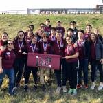 The Mercer Island High School Science Club members pose with a school flag.&nbsp;