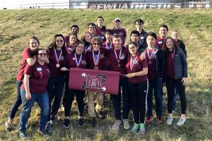 The Mercer Island High School Science Club members pose with a school flag.&nbsp;