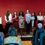 From left, guest speaker Hollis Wong-Wear introduces spoken word poem performers Naj Ali, Gabriela Jimenez, Meron Mekonnen, Sarah Crumrine, Christine Hau, Arwa Mokdad and Sophie Poole. Photo courtesy of Stanley Ann Dunham Scholarship Fund