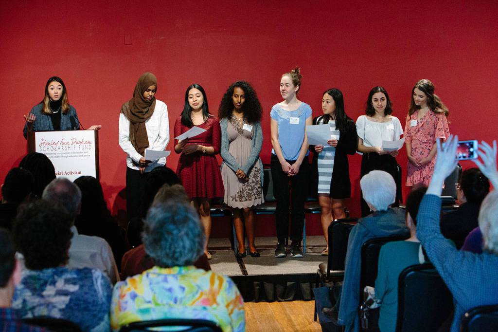 From left, guest speaker Hollis Wong-Wear introduces spoken word poem performers Naj Ali, Gabriela Jimenez, Meron Mekonnen, Sarah Crumrine, Christine Hau, Arwa Mokdad and Sophie Poole. Photo courtesy of Stanley Ann Dunham Scholarship Fund