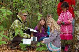 Linda Anchondo asks Junior Naturalist Laura Drake (in foreground) to explain how to identify Trilliums to Native Plant Garden Tour participants. Photo courtesy of Patrick Daugherty