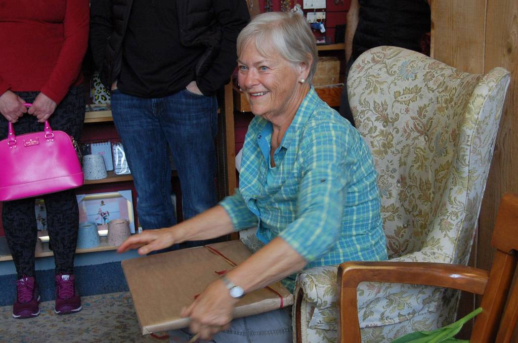 Island teacher Marilyn ONeill opens a present from her former students at Island Books on May 5. Katie Metzger/staff photo