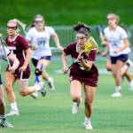 Photo courtesy of Rick Edelman/Rick Edelman Photography                                Mercer Island player Grace Fujinaga, who scored three goals in the state title game, carried the ball upfield while being chased by Bainbridge Island player Maggie Sweeney (left).