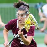 Photo courtesy of Rick Edelman/Rick Edelman Photography                                Mercer Island player Grace Fujinaga, who scored three goals in the state title game, carried the ball upfield while being chased by Bainbridge Island player Maggie Sweeney (left).