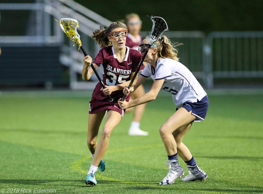 Photo courtesy of Rick Edelman/Rick Edelman Photography                                Mercer Islands Hannah Tiscornia, left, tries to maneuver around a Bainbridge Island player on May 18 at Starfire Sports Complex in Tukwila.