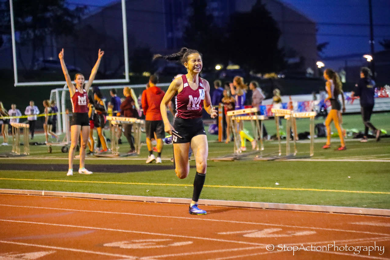 Photo courtesy of Don Borin/Stop Action Photography                                The Mercer Island Islanders 1600 relay squad consisting of Maya Virdell, Gretchen Blohm, Maggie Baker and Kayla Lee earned first place with a time of 3:52.75 at the Class 3A District II championships at the Southwest Athletic Complex in Seattle. Lee (pictured), who ran the fourth and final leg of the relay, was well in front of all other competitors down the stretch. Holy Names finished in a distant second place with a time of 4:00.44.