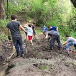 Scouts from Troop 457 dig ditches to enhance the drainage above Mercerdale Park as part of Mark Manginos Eagle Project.
