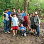 Scouts from Troop 457 dig ditches to enhance the drainage above Mercerdale Park as part of Mark Manginos Eagle Project.