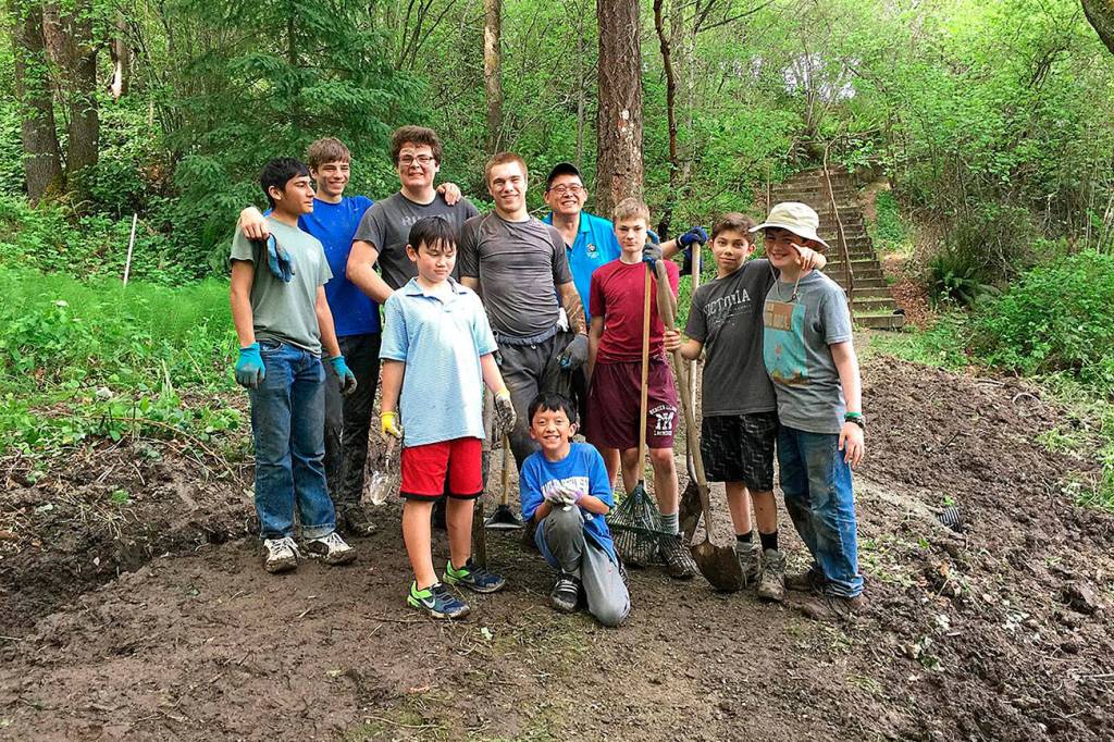 Scouts from Troop 457 dig ditches to enhance the drainage above Mercerdale Park as part of Mark Manginos Eagle Project.