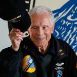 At the conclusion of his talk, 95-year-old Dick Nelms, who flew 35 missions in B-17 bombers in World War II, tips his cap to appreciative fellow military pilots at the Stanwood Eagles Thursday. (Dan Bates / The Herald)