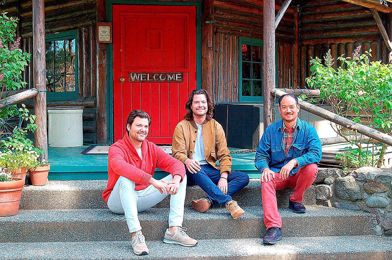 New owners of Central Whidbeys historic Captain Whidbey Inn are, from left, Matt French, his brother, Mike, and Eric Cheong. The three take a break on the inns porch. (Photo by Rick Chapman)