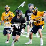 Photo courtesy of Rick Edelman/Rick Edelman Photography                                The Bellevue Wolverines boys lacrosse team earned a 8-6 victory against the Mercer Island Islanders in the Washington High School Boys Lacrosse Association 3A state title game on May 26 at the Starfire Sports Complex in Tukwila. Bellevue finished the 2018 season with an overall record of 17-2. The Islanders finished with an overall record of 16-7. Mercer Island player junior Donnie Howard, left, tries to maneuver around Bellevue player in the title contest.