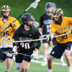 Photo courtesy of Rick Edelman/Rick Edelman Photography                                The Bellevue Wolverines boys lacrosse team earned a 8-6 victory against the Mercer Island Islanders in the Washington High School Boys Lacrosse Association 3A state title game on May 26 at the Starfire Sports Complex in Tukwila. Bellevue finished the 2018 season with an overall record of 17-2. The Islanders finished with an overall record of 16-7. Mercer Island player junior Donnie Howard, left, tries to maneuver around Bellevue player in the title contest.