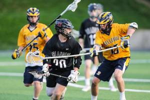 Photo courtesy of Rick Edelman/Rick Edelman Photography                                The Bellevue Wolverines boys lacrosse team earned a 8-6 victory against the Mercer Island Islanders in the Washington High School Boys Lacrosse Association 3A state title game on May 26 at the Starfire Sports Complex in Tukwila. Bellevue finished the 2018 season with an overall record of 17-2. The Islanders finished with an overall record of 16-7. Mercer Island player junior Donnie Howard, left, tries to maneuver around Bellevue player in the title contest.