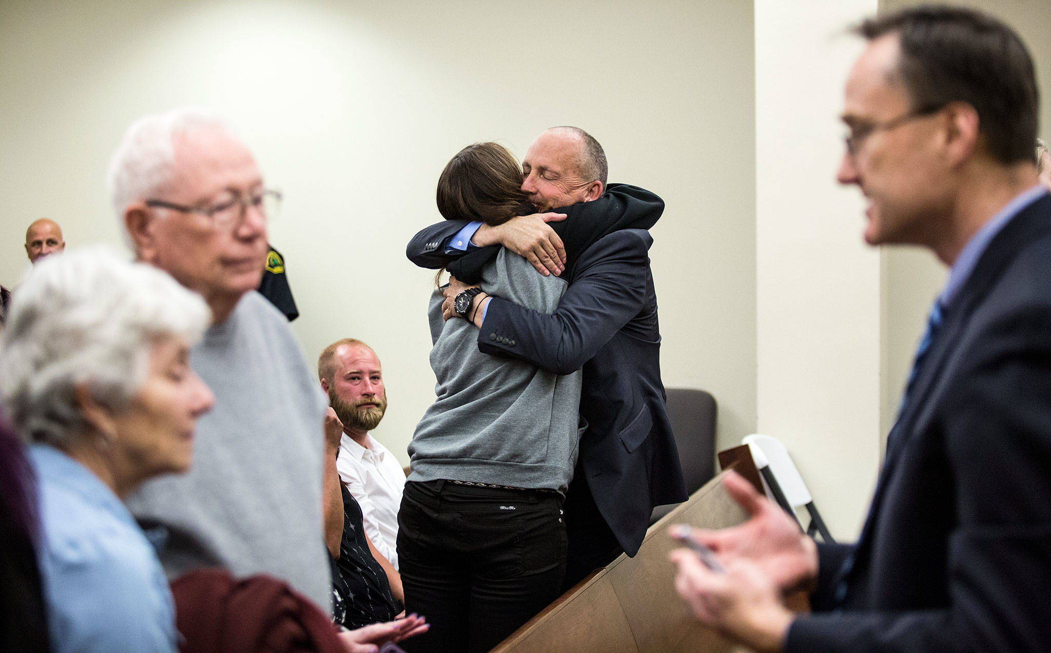 Snohomish County detective Dave Fontenot (center) is hugged as friends and family of Monique Patenaude and Patrick Shunn react to the guilty verdict for John Reed at the Snohomish County Courthouse on Wednesday in Everett. At right,Snohomish County chief criminal deputy prosecutor Craig Matheson talks with Shunns parents (left). (Andy Bronson / The Herald)