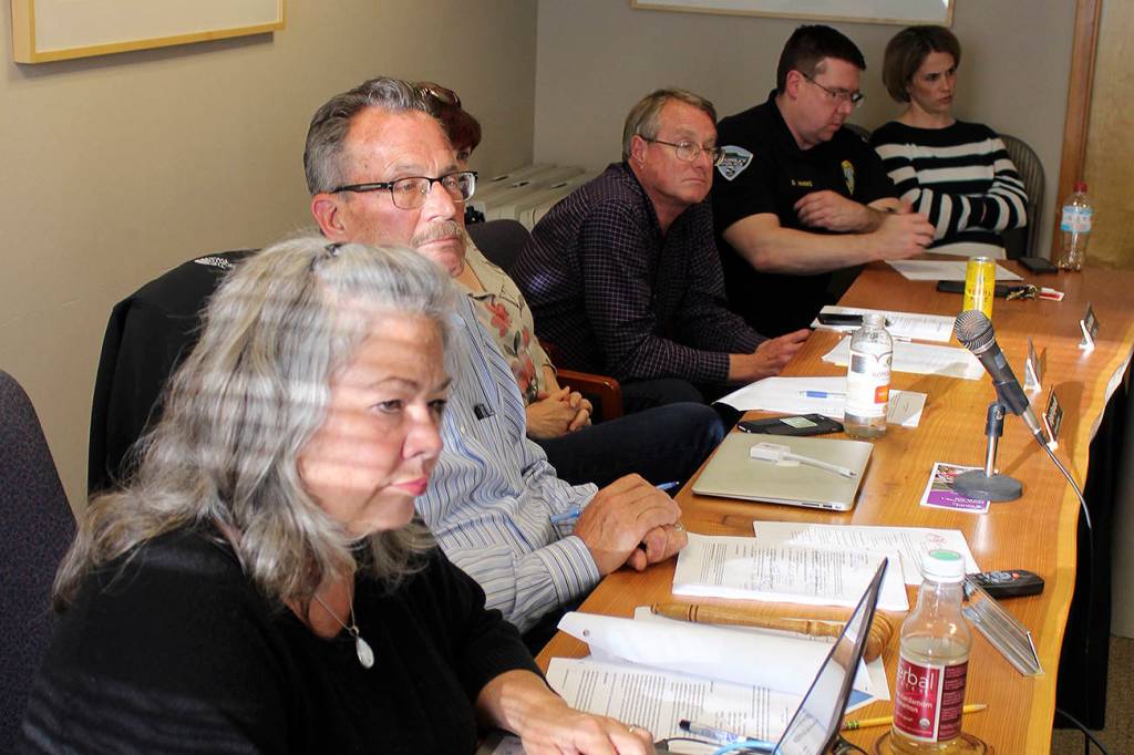 Listening during public comment at a Langley City Council meeting are, left to right, Finance director Debbie Mahler, Mayor Tim Callison, Planning director Brigid Reynolds, Public Works director Stan Berryman, Chief of Police David Marks and his friend Tara Hoflack. Photo by Patricia Guthrie/Whidbey News Group