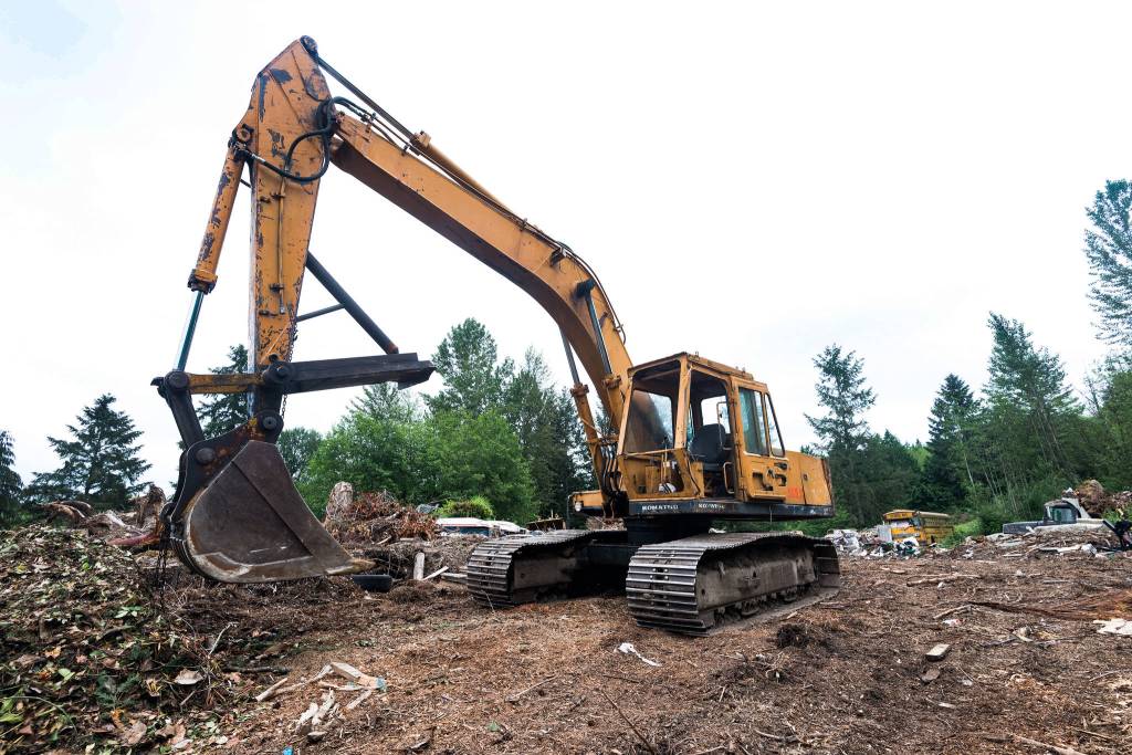Pillons own excavator sits atop the hill overlooking his junkyard. It is one of the few functional vehicles on the property. Photo by Caean Couto