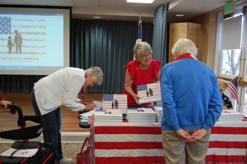 Author Karen Robbins sells and signs copies of her book, Flags Across America, on June 14. Katie Metzger/staff photo
