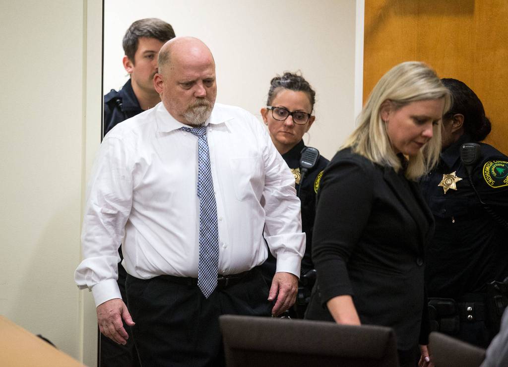 Led by defense attorney Rachel Forde, William Earl Talbott II enters Snohomish County Superior Court on Tuesday in Everett to be arraigned for the 1987 murders of Jay Cook, 20, and Tanya Van Cuylenborg, 18. (Andy Bronson / The Herald)