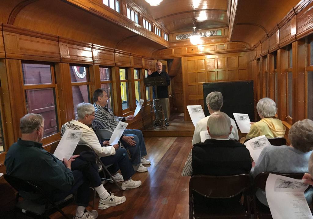 Covenant Shores residents hold an impromptu religious service in a 19th century railroad car. Photo courtesy of Greg Asimakoupoulos