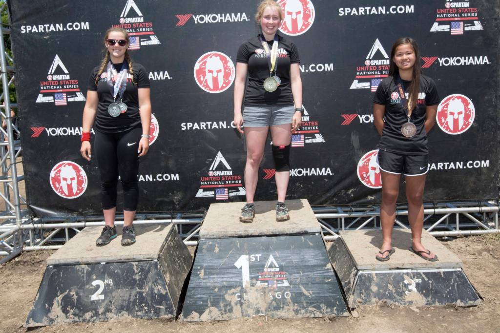 Mercer Island resident Anna Bolger (far right) earned a third-place finish in the 14-17 year-old age group at the Spartan Race Chicago Super and the Spartan Race Chicago Sprint on June 23-24 at the Richmond Hunting Club in Chicago.                                Bolger clocked a time of 3:19:35 in the Spartan Race Chicago Super and a time of 2:08:57 in the Spartan Race Chicago Sprint. The Super, a Spartan Signature Race, included 8-10 miles of 24-29 obstacles for racers to tackle at the Richmond Hunting Club. The Sprint event consisted of 3-5 miles and 20-23 obstacles. The courses features miles of technical terrain, steep elevation and obstacles to push competitors to their limits.                                Photo courtesy of Flora Goodman/Elevate Communications