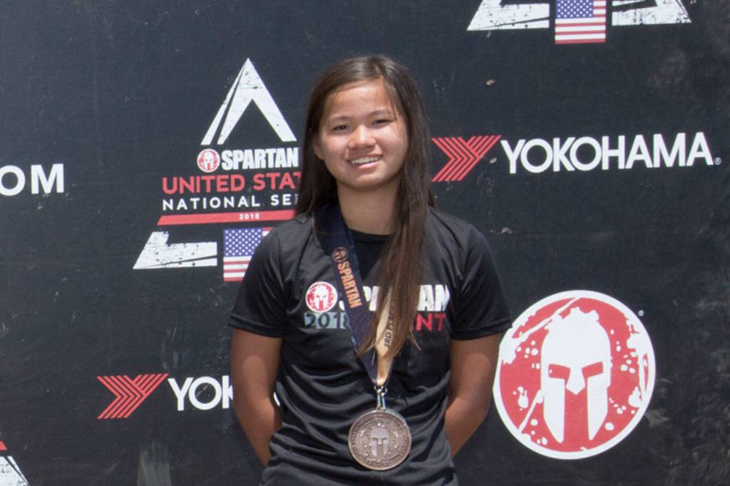 Mercer Island resident Anna Bolger (far right) earned a third-place finish in the 14-17 year-old age group at the Spartan Race Chicago Super and the Spartan Race Chicago Sprint on June 23-24 at the Richmond Hunting Club in Chicago.                                Bolger clocked a time of 3:19:35 in the Spartan Race Chicago Super and a time of 2:08:57 in the Spartan Race Chicago Sprint. The Super, a Spartan Signature Race, included 8-10 miles of 24-29 obstacles for racers to tackle at the Richmond Hunting Club. The Sprint event consisted of 3-5 miles and 20-23 obstacles. The courses features miles of technical terrain, steep elevation and obstacles to push competitors to their limits.                                Photo courtesy of Flora Goodman/Elevate Communications