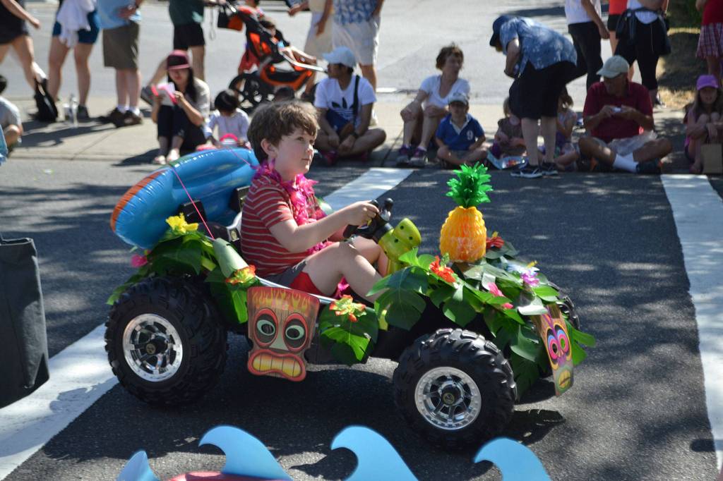 Representing the Island Vibes theme and Pixie Hill Preschool, a young Islander rides in the Summer Celebration parade. Katie Metzger/staff photo