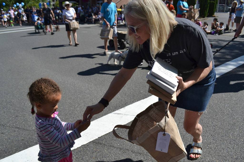 Island Books owner Laurie Raisys hands out books and other treats at the Summer Celebration parade in downtown Mercer Island. Katie Metzger/staff photo