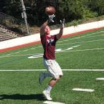 Mercer Island senior football player John Majewski hauls in a pass during a player led team workout on July 18 on Mercer Island. The Islanders, who finished with an overall record of 7-4 during the 2018 season, are looking to build on last years sensational season on the gridiron.                                Shaun Scott, staff photo