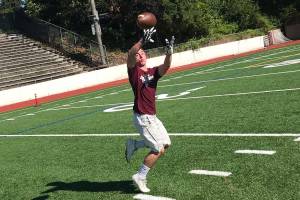 Mercer Island senior football player John Majewski hauls in a pass during a player led team workout on July 18 on Mercer Island. The Islanders, who finished with an overall record of 7-4 during the 2018 season, are looking to build on last years sensational season on the gridiron.                                Shaun Scott, staff photo
