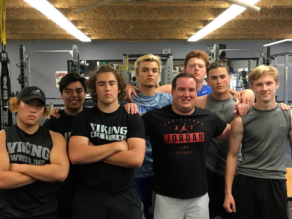Sound Publishing sportswriter Shaun Scott poses for a quick picture with members of the Bellevue Christian Vikings football team following a weight training session on July 19 at Bellevue Christian School in Bellevue.                                Photo courtesy of Todd Green