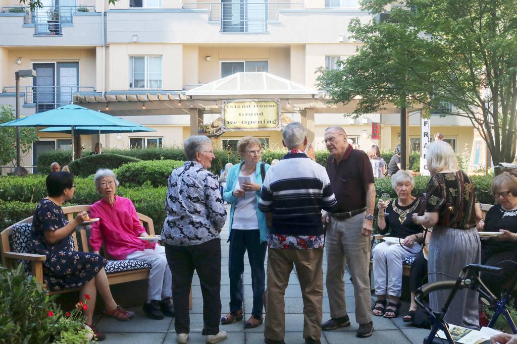 Attendees at Island Houses grand opening on July 31 gather in the courtyard. Katie Metzger/staff photo