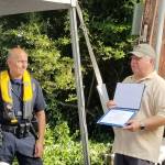 Sgt. Brian Noel receives the 2018 National Association of State Boating Law Administrators Boating Law Officer of the Year for Washington State from Hoyle Hodges with Washington State Parks. Courtesy of the Mercer Island Police and Emergency Management Facebook Page