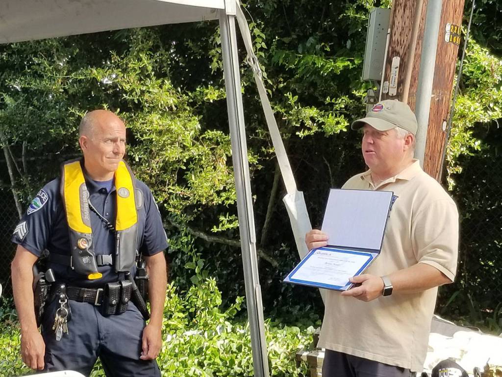 Sgt. Brian Noel receives the 2018 National Association of State Boating Law Administrators Boating Law Officer of the Year for Washington State from Hoyle Hodges with Washington State Parks. Courtesy of the Mercer Island Police and Emergency Management Facebook Page