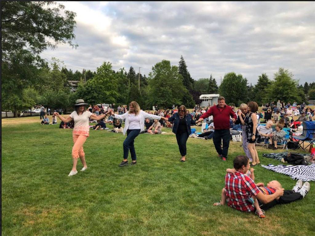 Islanders dance at a previous Mostly Music performance. While other concerts in the annual summer series have taken place on Thursday evenings, the last one will be on Friday, and will feature a Journey cover band, food truck rodeo and Womens Equality Day celebration. Photo courtesy of the city of Mercer Island
