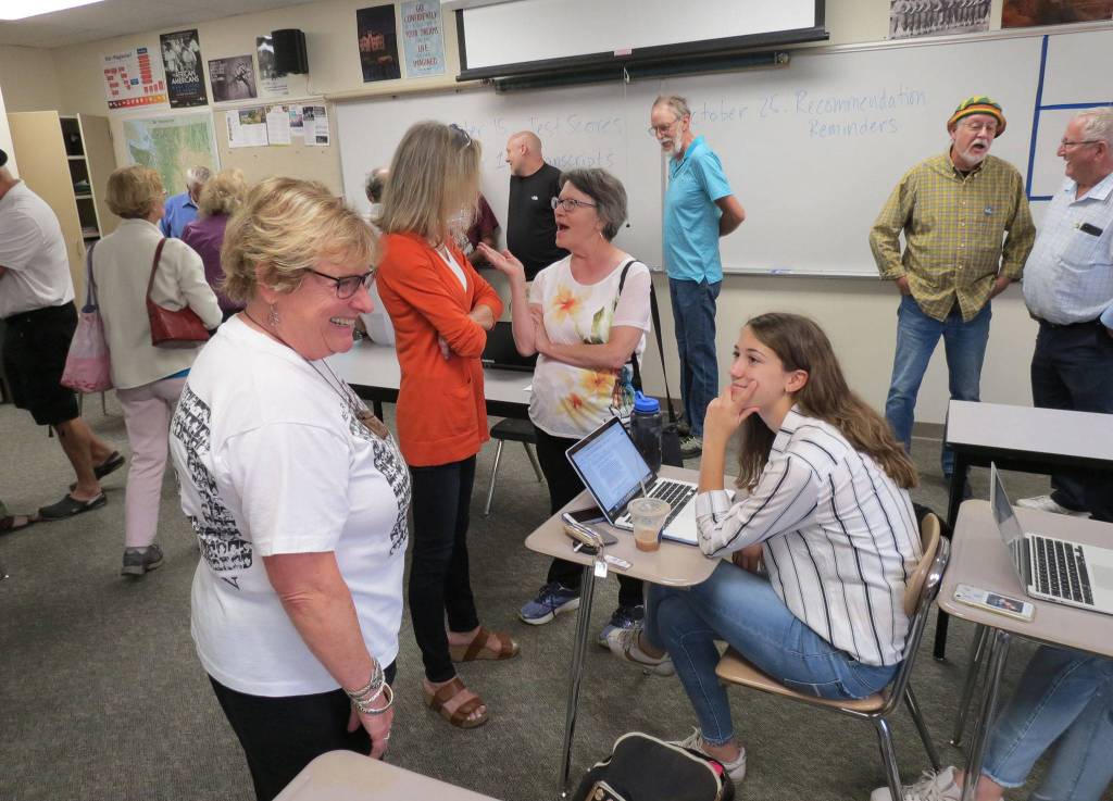 Members of the MIHS Class of 1968, including Chris Mochel, tour classrooms at their alma mater. Photo courtesy of Clay Eals