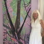 Mercer Island artist Pat Howie poses with her work. Photo courtesy of MIVAL