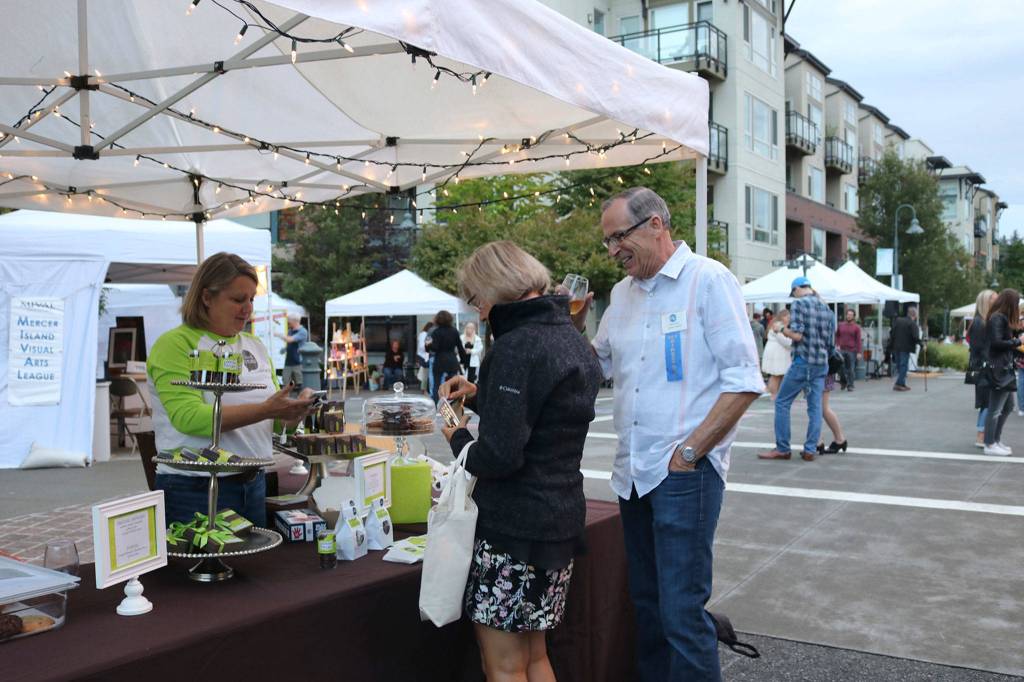Ralph Swanson, board president of the Mercer Island Chamber of Commerce, enjoys some Island Treats at Art Uncorked. Katie Metzger/staff photo