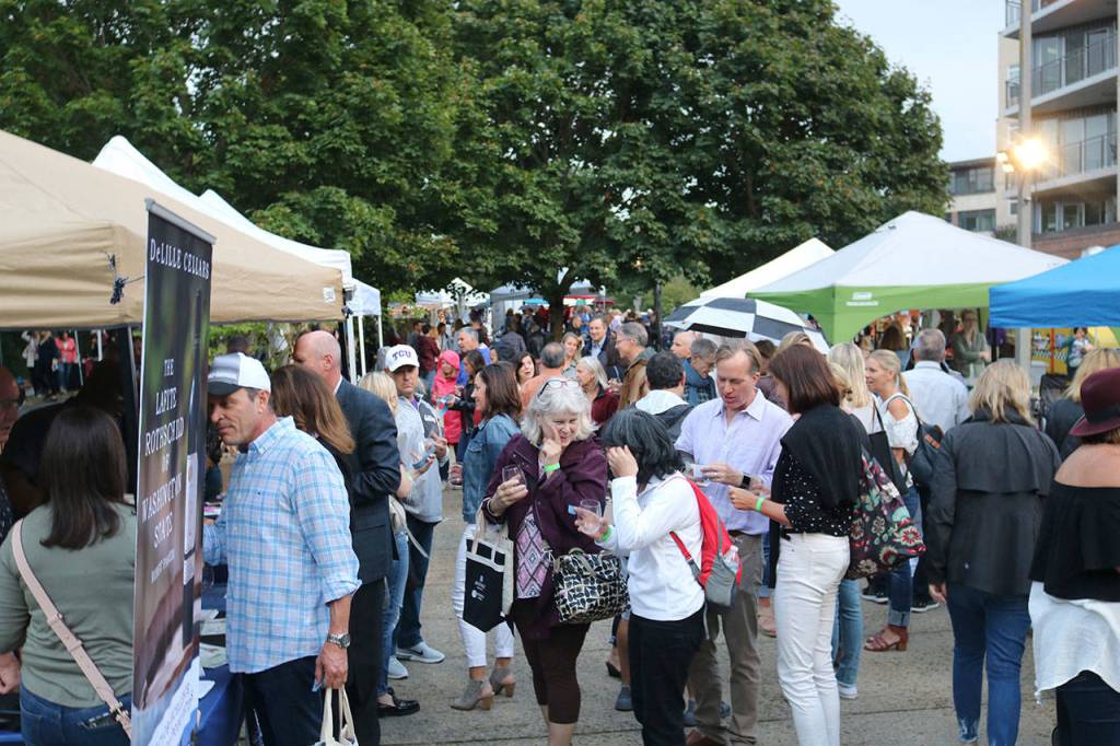 A crowd gathers in the sculpture garden in Mercer Islands Town Center for the annual Art Uncorked event. Katie Metzger/staff photo