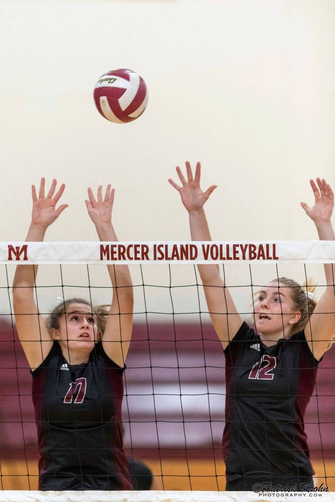 Mercer Island volleyball players Anika Iverson, left, and Quinn Casey, right, leap into the air against the Skyline Spartans in a non-league contest on Sept. 12 on Mercer Island. Skyline defeated Mercer Island 3-1 in the matchup. Photo courtesy of Patrick Krohn/Patrick Krohn Photography