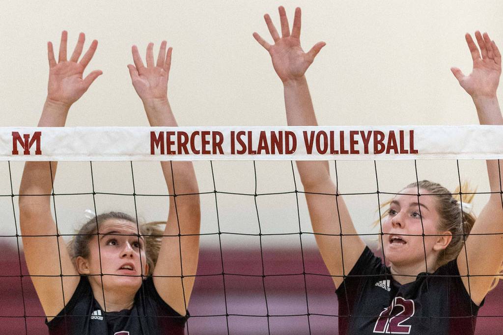 Mercer Island volleyball players Anika Iverson, left, and Quinn Casey, right, leap into the air against the Skyline Spartans in a non-league contest on Sept. 12 on Mercer Island. Skyline defeated Mercer Island 3-1 in the matchup. Photo courtesy of Patrick Krohn/Patrick Krohn Photography