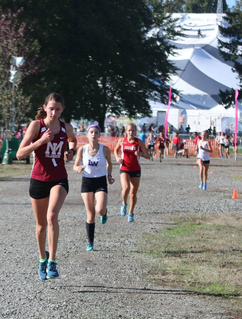 With the Cirque du Soleil big top in the background, Mercer Islands Maggie Baker takes charge with Lake Washington and Juanita runners behind her on Sept. 17 at Marymoor Park. Andy Nystrom / staff photo