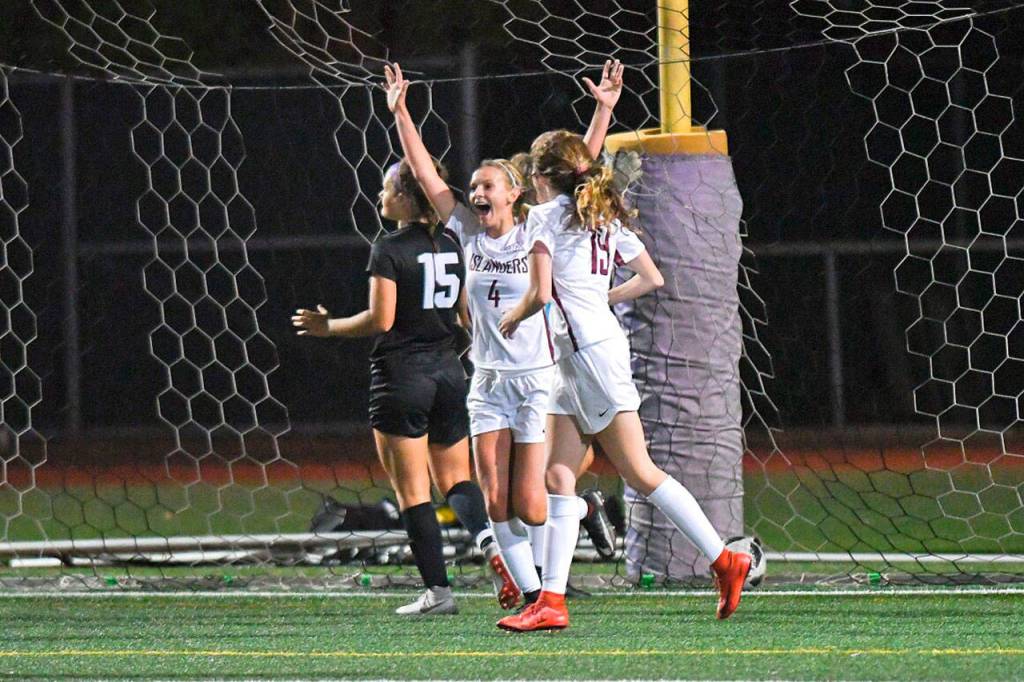 Mercer Island senior captain Jackie Stenberg, left, celebrates scoring in regular time while senior Jackie Gilroy joins her during the Islanders 2-1 overtime girls soccer victory over Lake Washington on Sept. 20. Courtesy of Dale Garvey