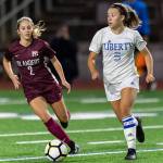 Mercer Island senior midfielder Emily Arron, left, puts pressure on Liberty defender Cameron Nelson, right, in a matchup featuring two of the top soccer programs in the 3A/2A KingCo Division. Mercer Island earned a 2-1 comeback victory on Sept. 25 on Mercer Island. Photo courtesy of Patrick Krohn/Patrick Krohn Photography