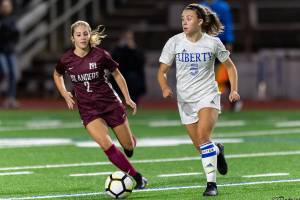 Mercer Island senior midfielder Emily Arron, left, puts pressure on Liberty defender Cameron Nelson, right, in a matchup featuring two of the top soccer programs in the 3A/2A KingCo Division. Mercer Island earned a 2-1 comeback victory on Sept. 25 on Mercer Island. Photo courtesy of Patrick Krohn/Patrick Krohn Photography