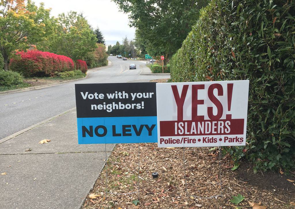 Signs supporting and opposing the citys ballot measure can be found all over the Island. Katie Metzger/staff photo